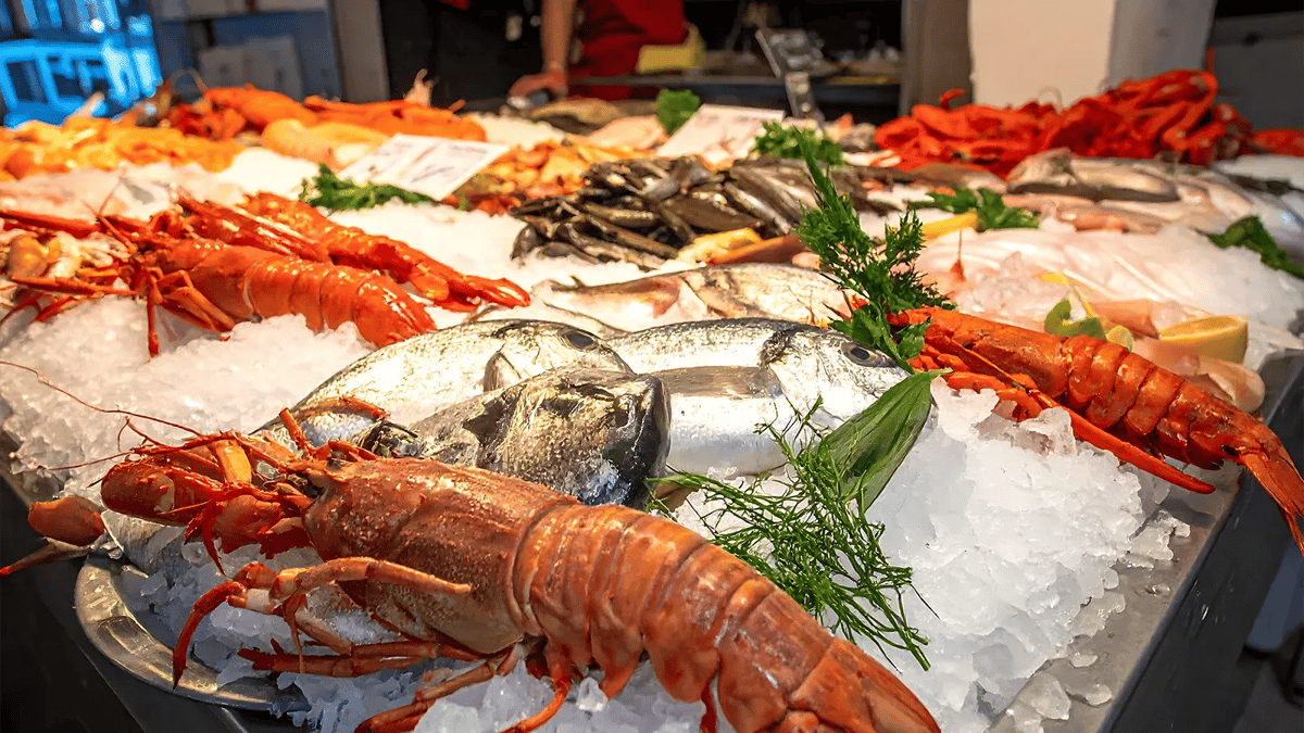 Display of fresh seafood on ice at a market stall