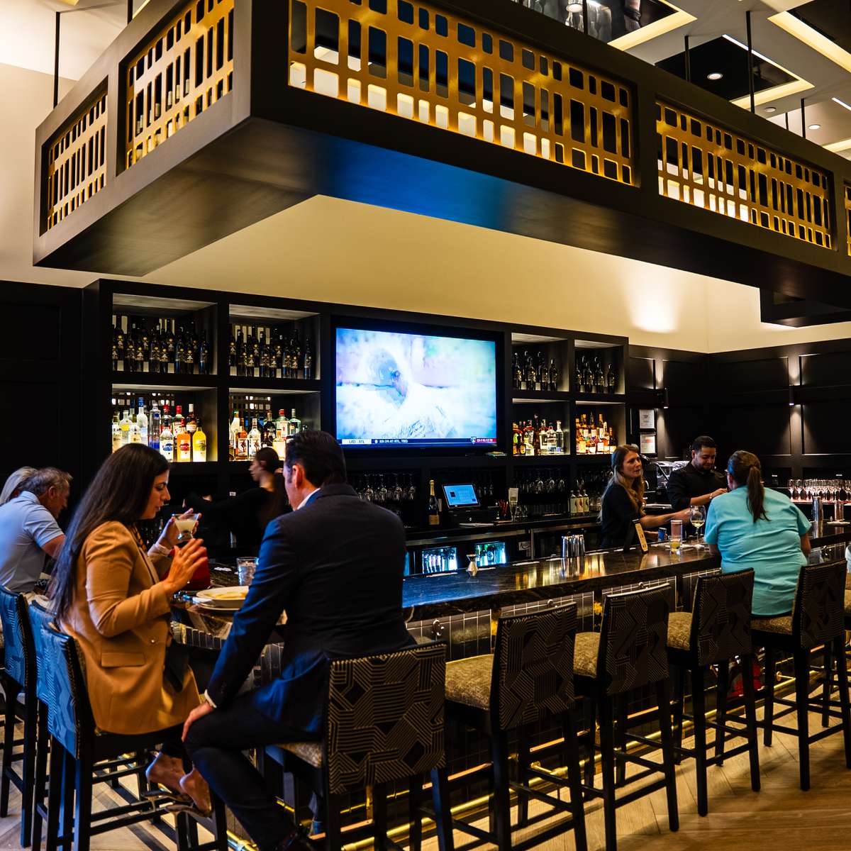 Visitors sitting at the bar