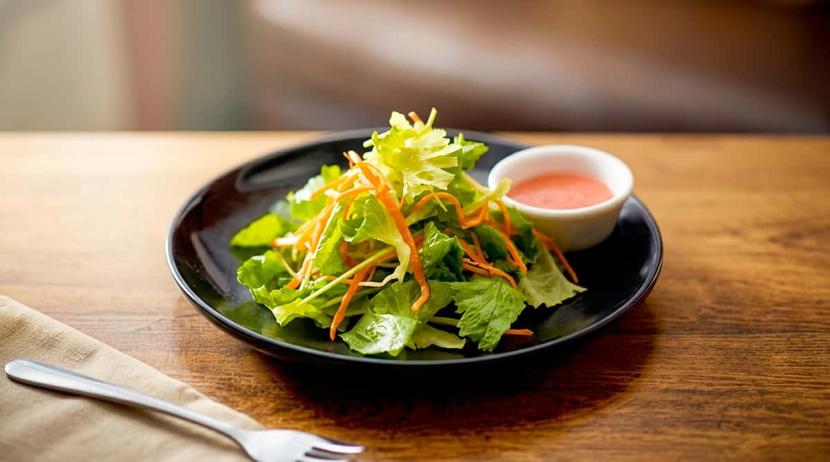 Fresh garden salad with mixed greens and vegetables served with dipping sauce