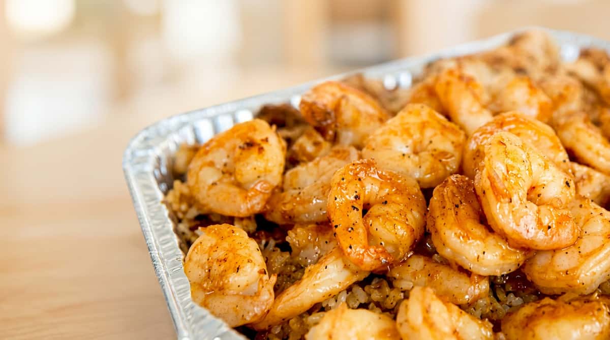 Garlic shrimp served over fluffy rice with a savory golden-brown glaze