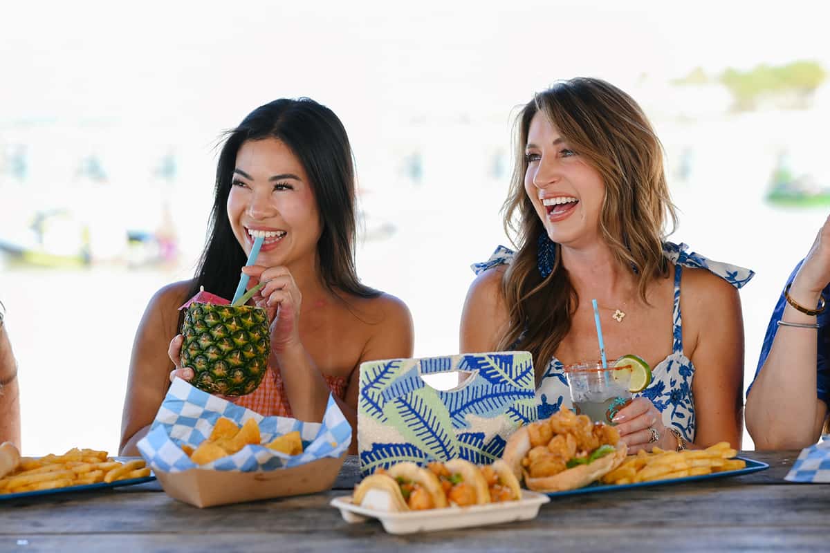 Women enjoying cocktails and dishes