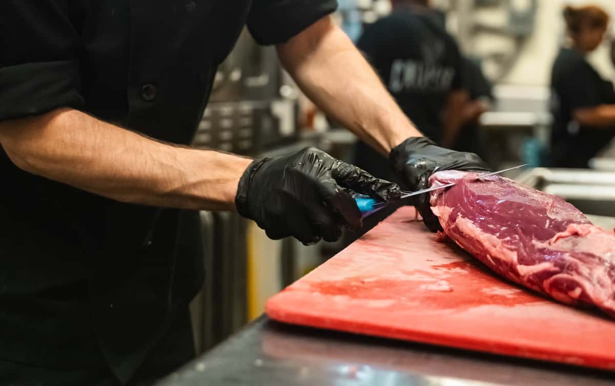 Chef Michael Butchering filet mignon in house