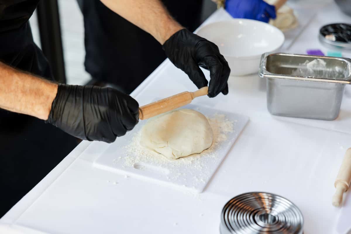 Rolling dough at a Butter My Biscuit team building event