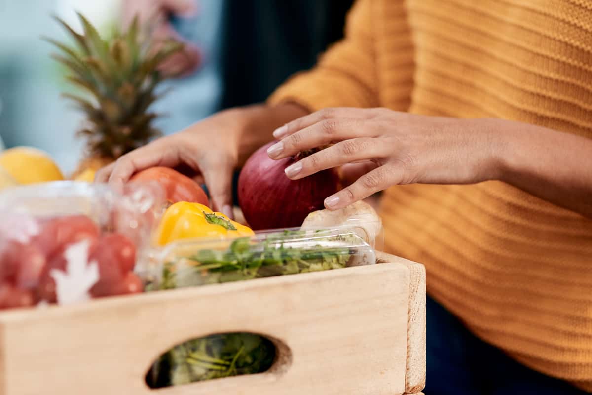 Woman unpacking fruits and vegetables