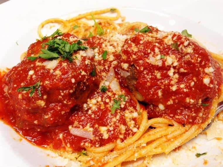 spaghetti with meatballs in marinara sauce and sprinkled with parmesan