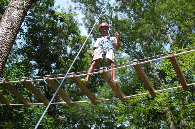 camper walking on a wood bridge