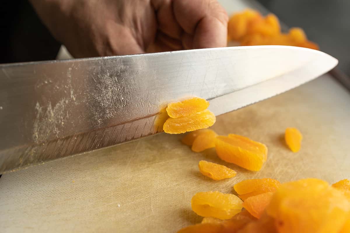 chef cutting dried apricots