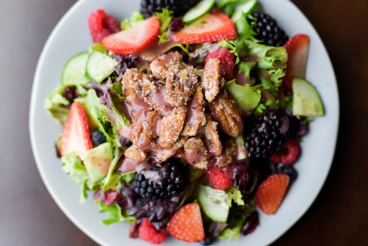 The season's bounty of strawberries, blackberries, raspberries, blueberries, dried cranberries, crisp cucumber, goat cheese & sugared pecans on spring mix with pomegranate vinaigrette.