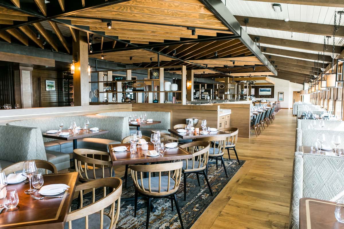 Booth and table dining with light wood and black color accents