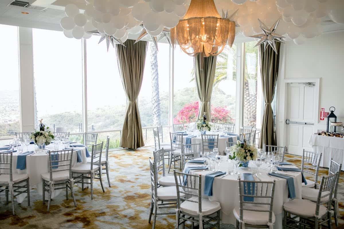 White and blue event set up with hanging stars and white balloons
