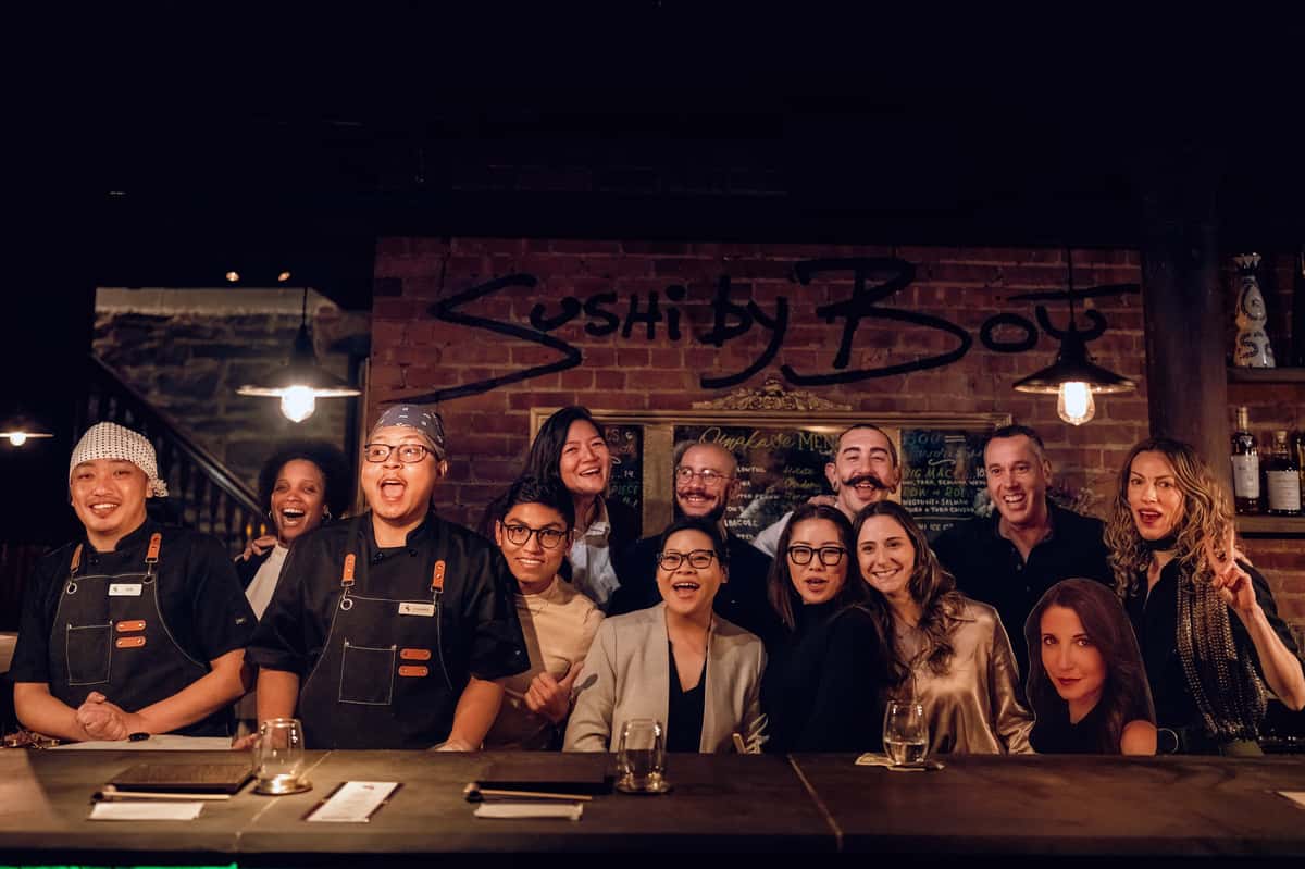 Group photo of Sushi By Bou team members