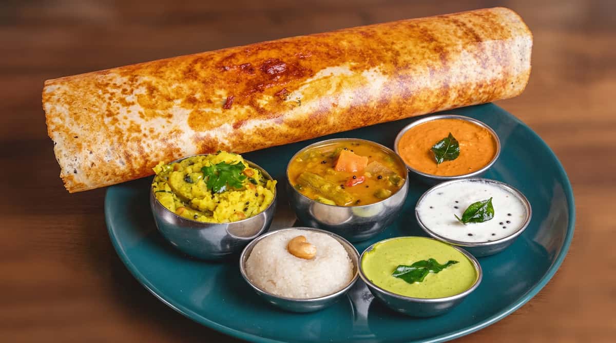 Crispy masala dosa served with sambar and traditional coconut, tomato, and mint chutneys at Chaat Diner, a pure vegetarian Indian restaurant in San Francisco.