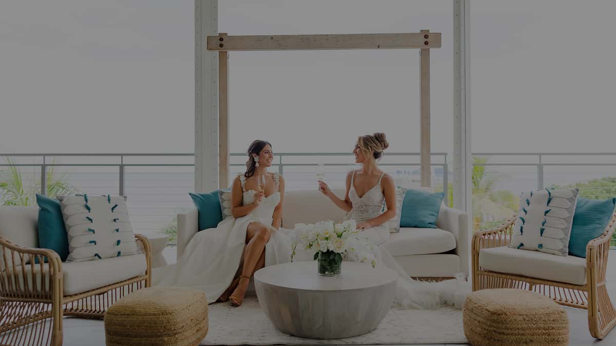 Two brides sitting on the oceanfront patio at Oceanic Pompano