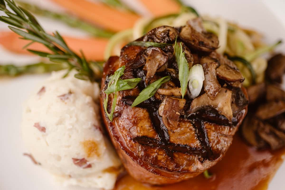 Steak Au Jus served with roasted asparagus and carrots