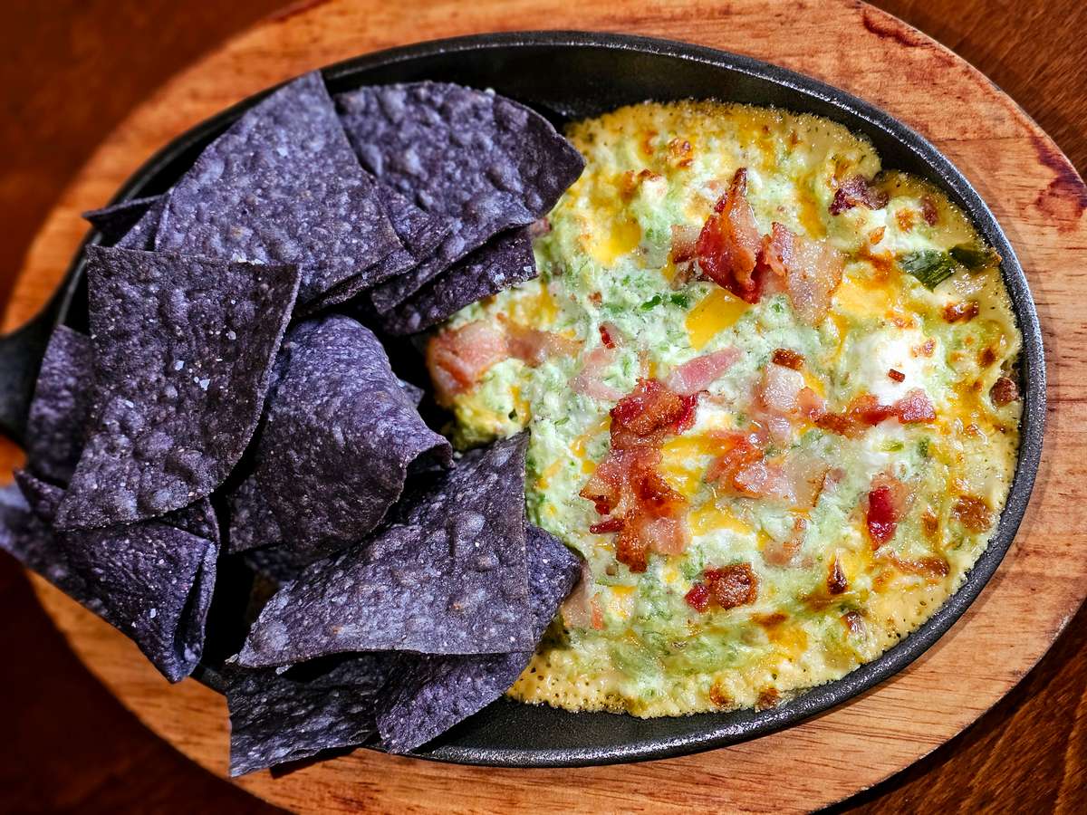 Cheesy, gooey, bacon-y and just a little spicy. Made with fresh jalapeños and topped with more bacon! Served with house made blue corn tortilla chips.