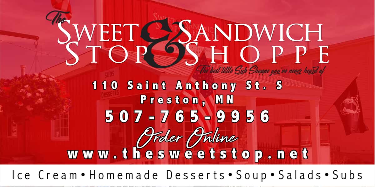 Vibrant red advertisement for The Sweet & Sandwich Stop Shoppe, featuring its storefront with an American flag, hanging flowers, and text detailing ice cream, subs, and desserts.