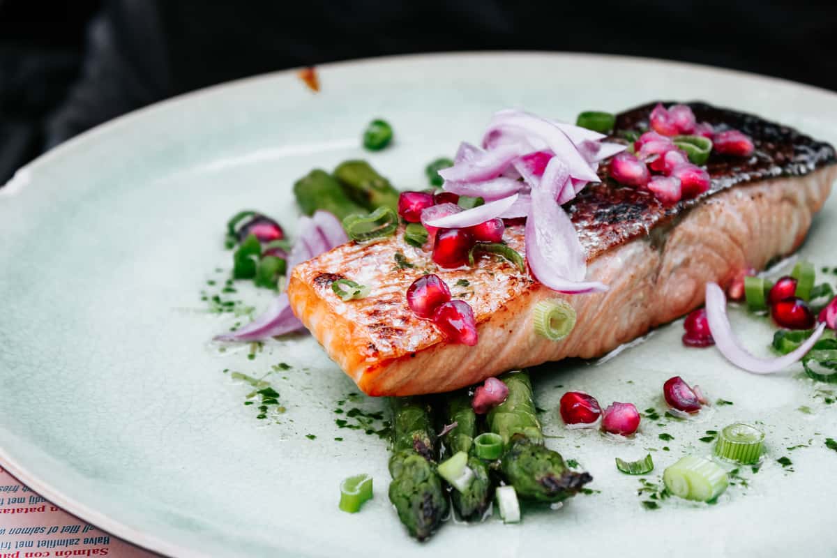 baked salmon with asparagus, onions, leeks and pomegranate