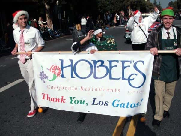 People holding a Hobee's parade banner
