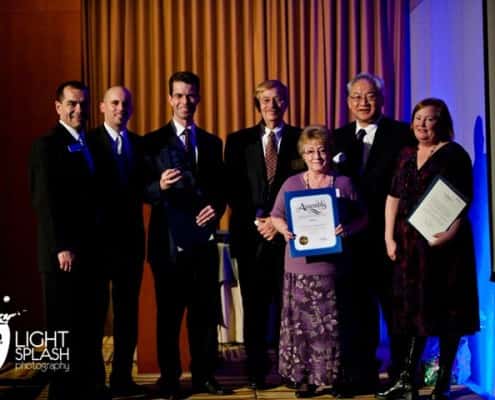 Leadership holding an award 