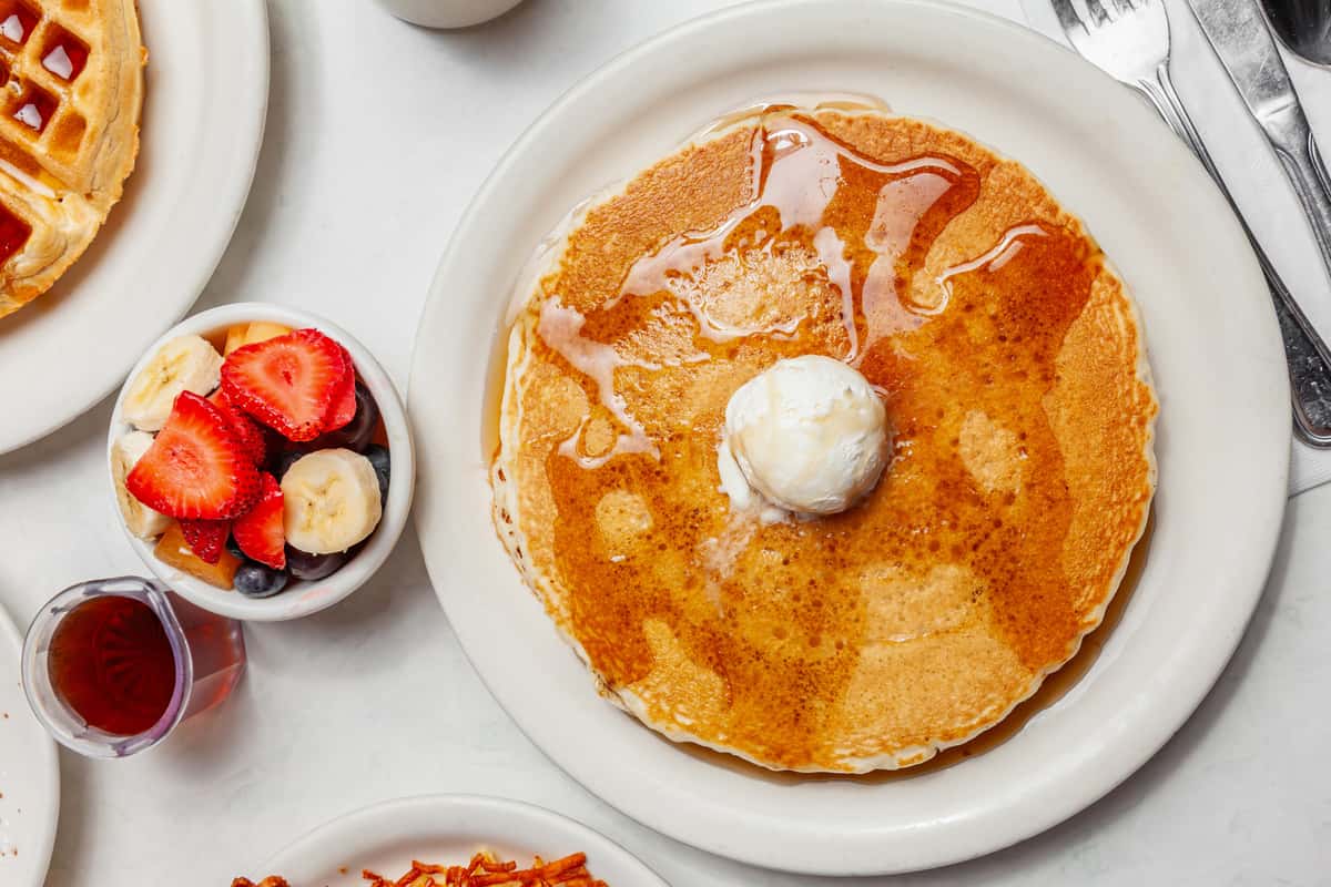 Pancake and cream with strawberries and syrup