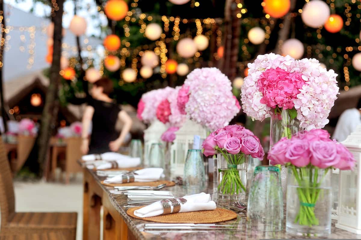 Outdoor wedding table decorated with pink flowers