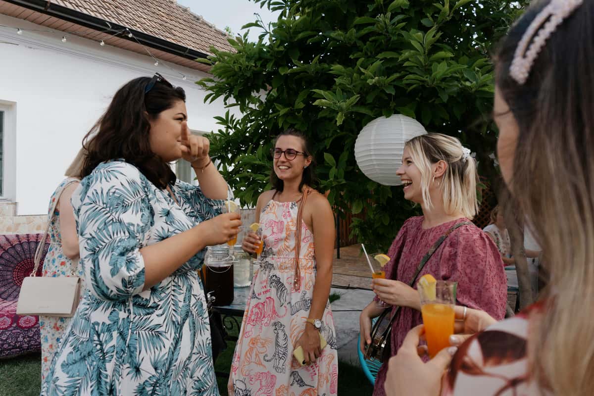 Women chatting and drinking at a garden party
