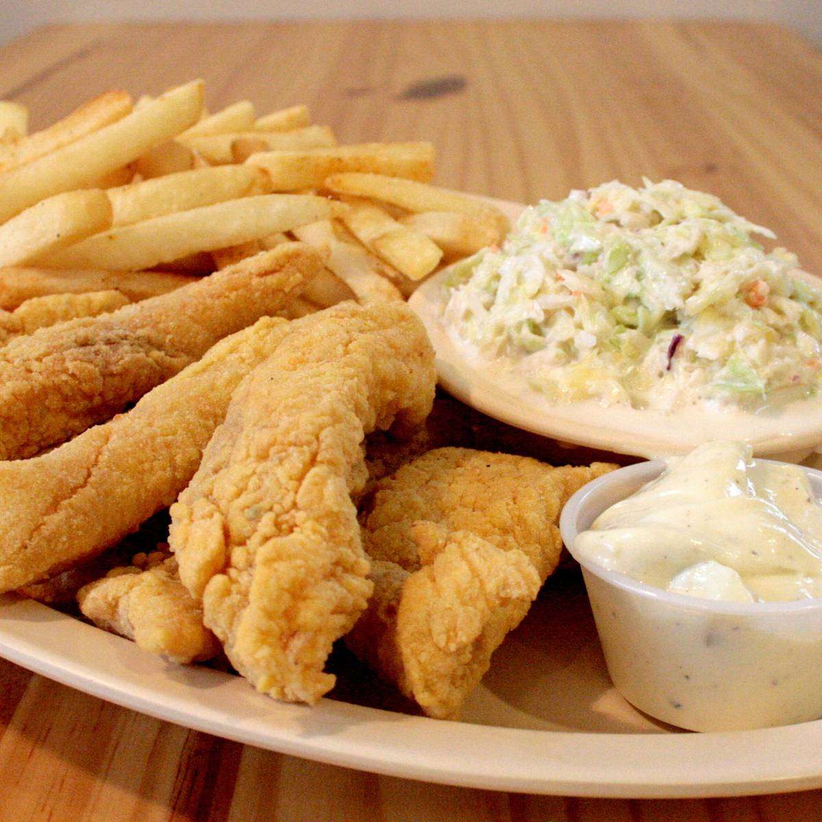 Fried fish and shrimp with french fries, coleslaw, and tartar sauce