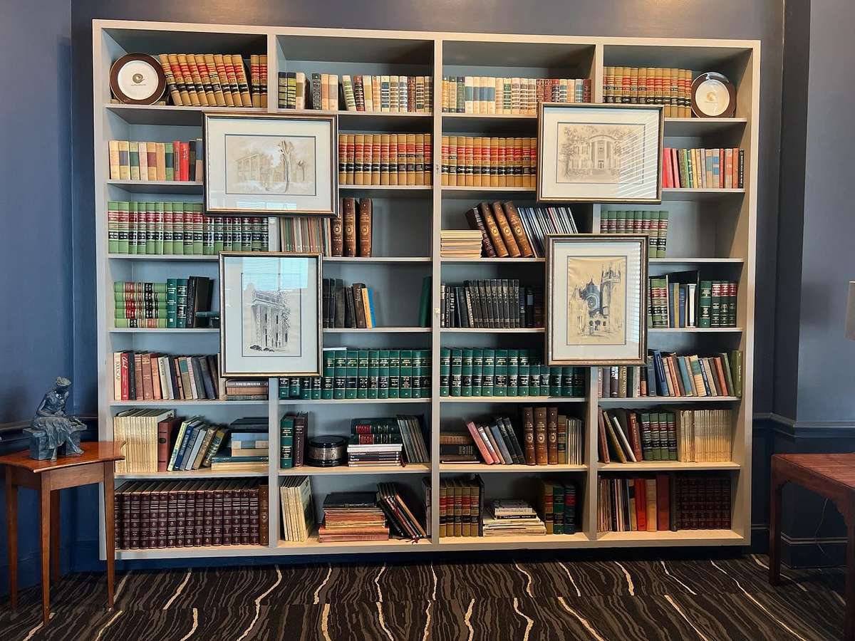 large bookcase with framed artwork