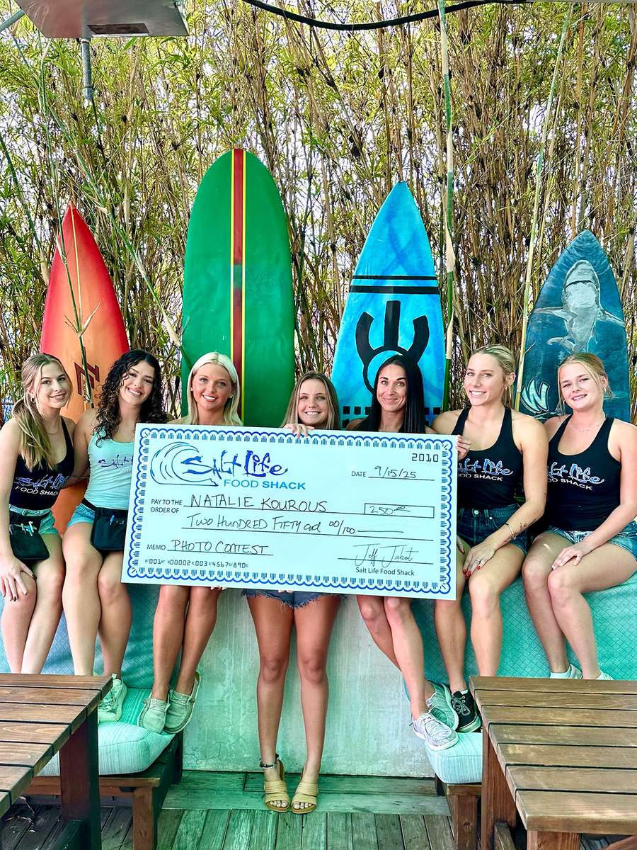 Salt Life photo contest group holding a check