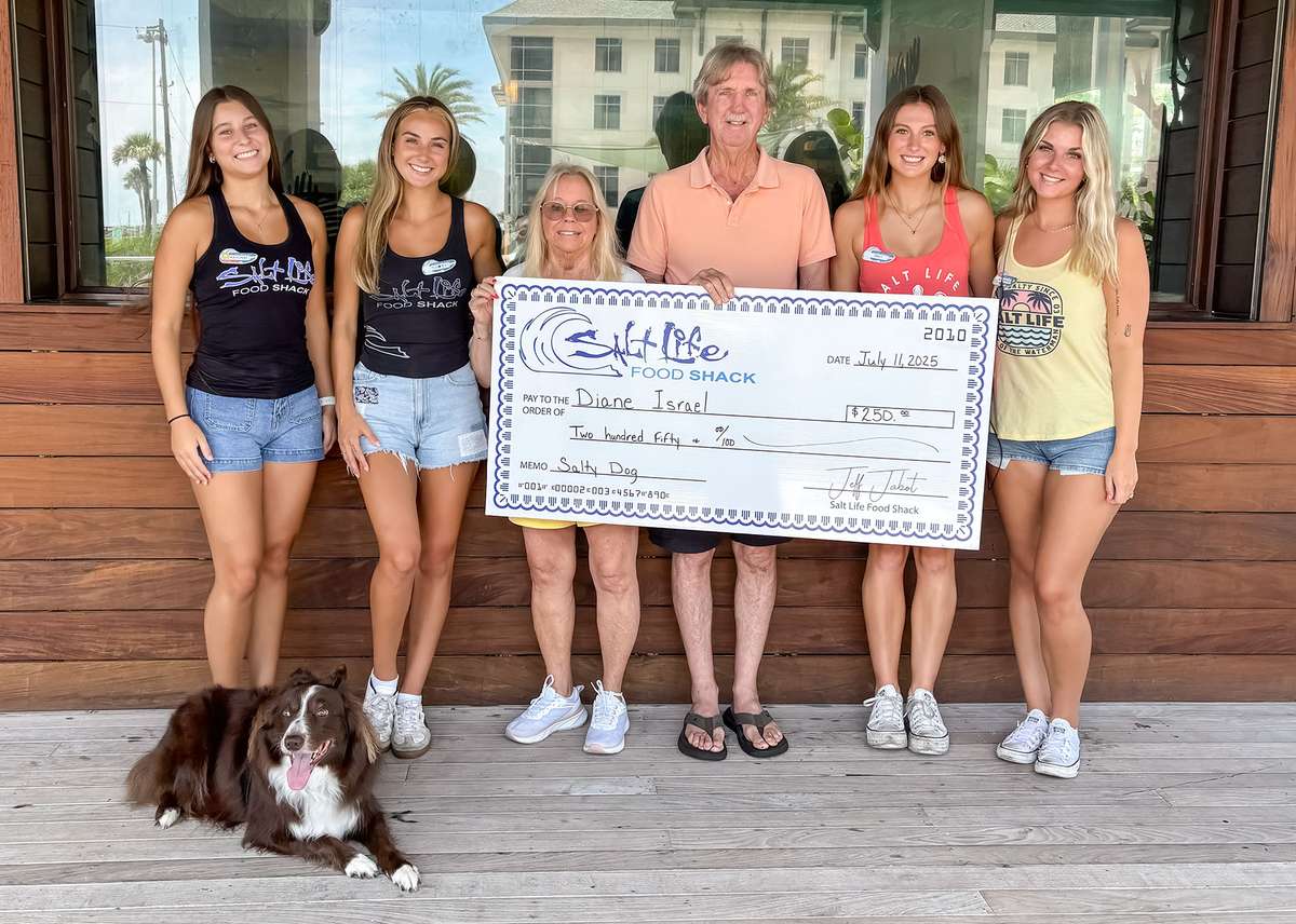 Salt Life photo contest winner holding a check
