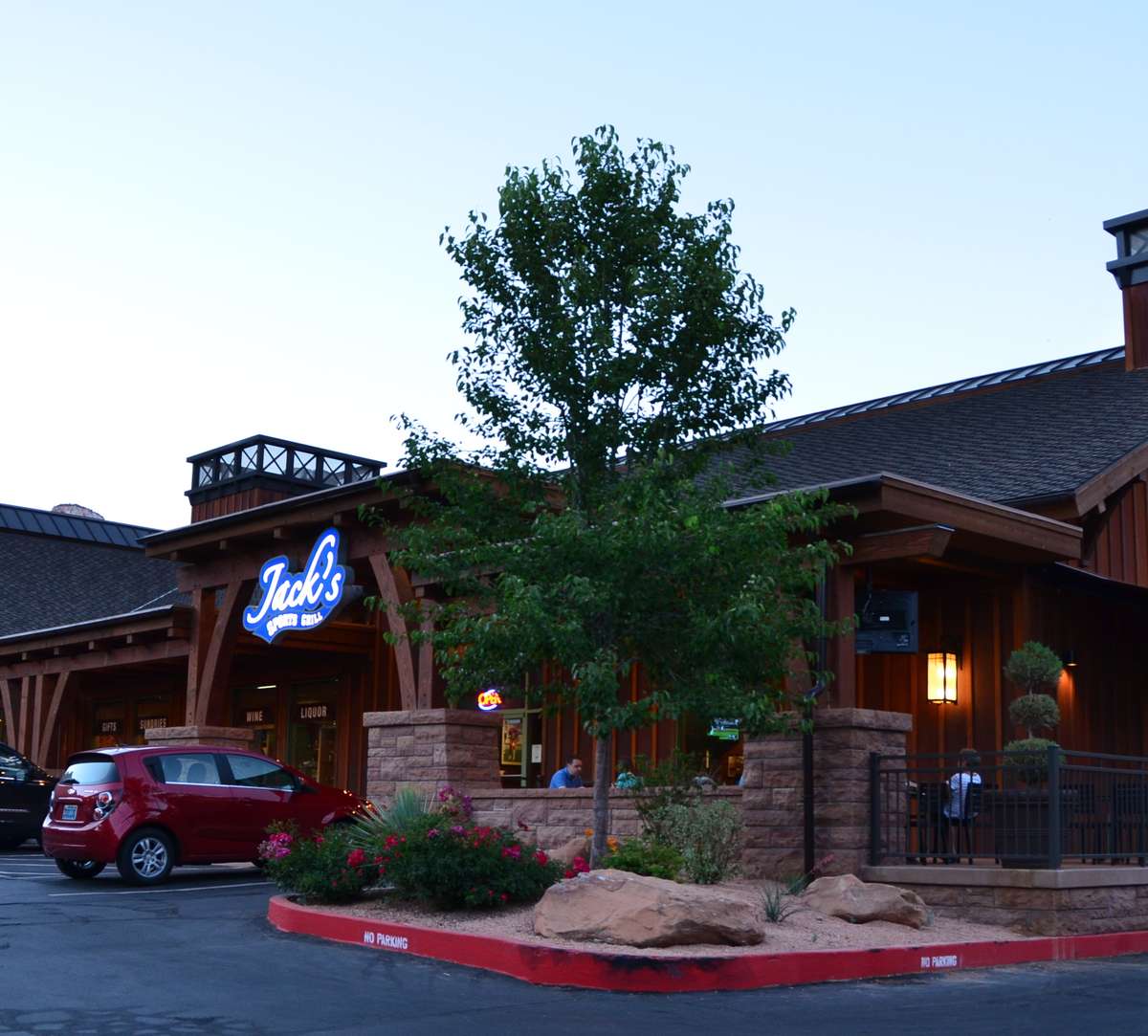 Exterior of Jack's restaurant at day, with its illuminated sign visible against a dark sky.