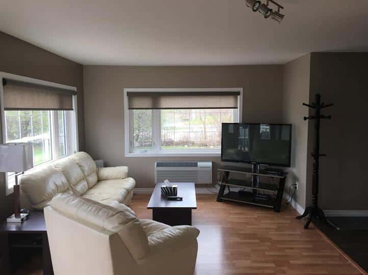 Living room with a TV, coffee table, and a couch