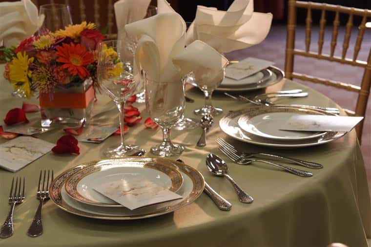 table setup with utensils, plates and flowers
