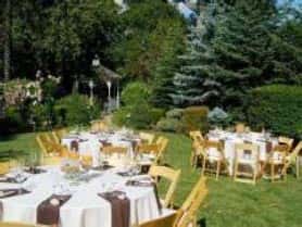Covered tables outdoors on grass.