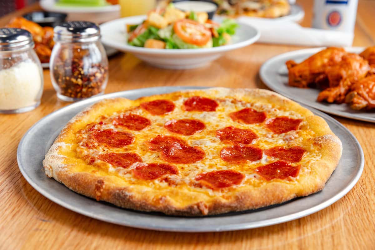 Pizza and wings on a table