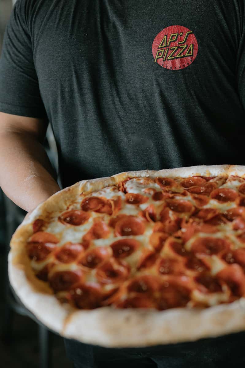 AP's shirt holding pizza