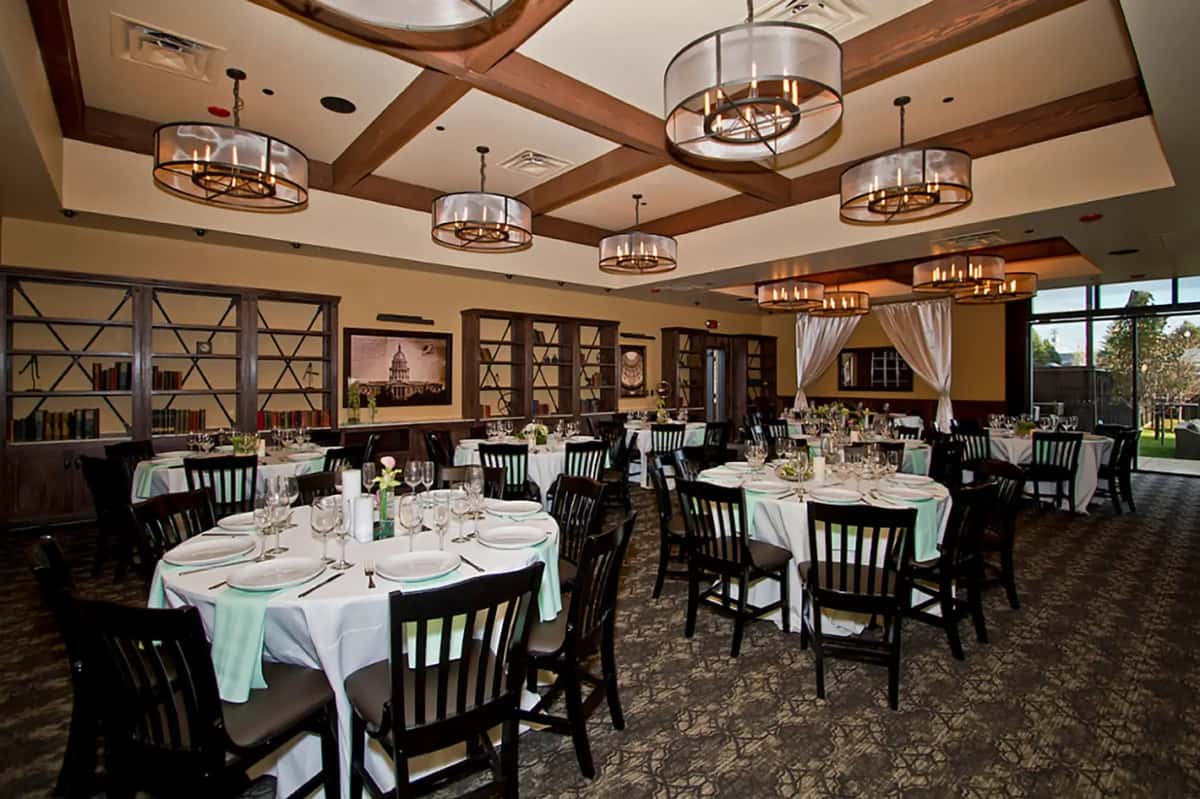 Spacious banquet room with round tables, upscale décor, and flexible seating for weddings, corporate events, and private celebrations.