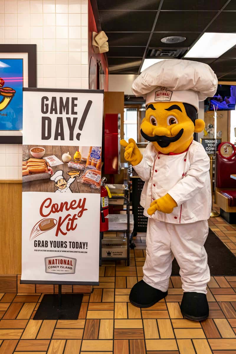 Mr. Pop standing beside a Coney Kit sign