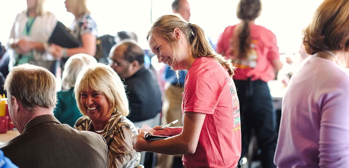 Waitress taking orders from guests