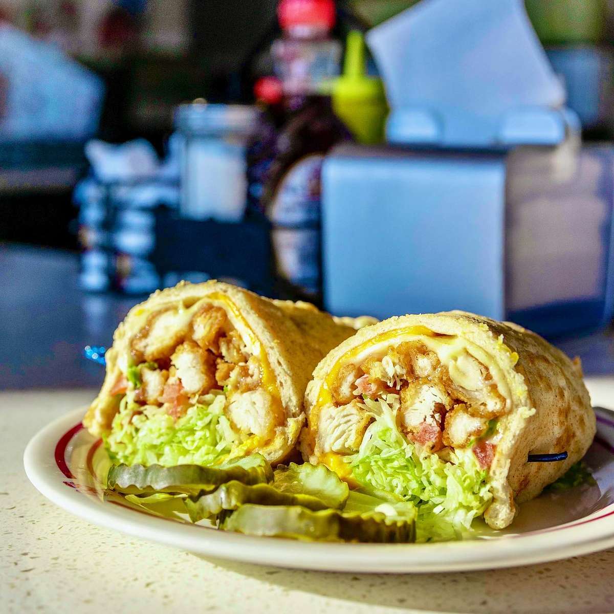 Premium chicken tenderloins cooked golden brown and crispy, wrapped in our own special recipe pita bread with Swiss and American cheese, shredded lettuce, diced tomatoes and mayo.