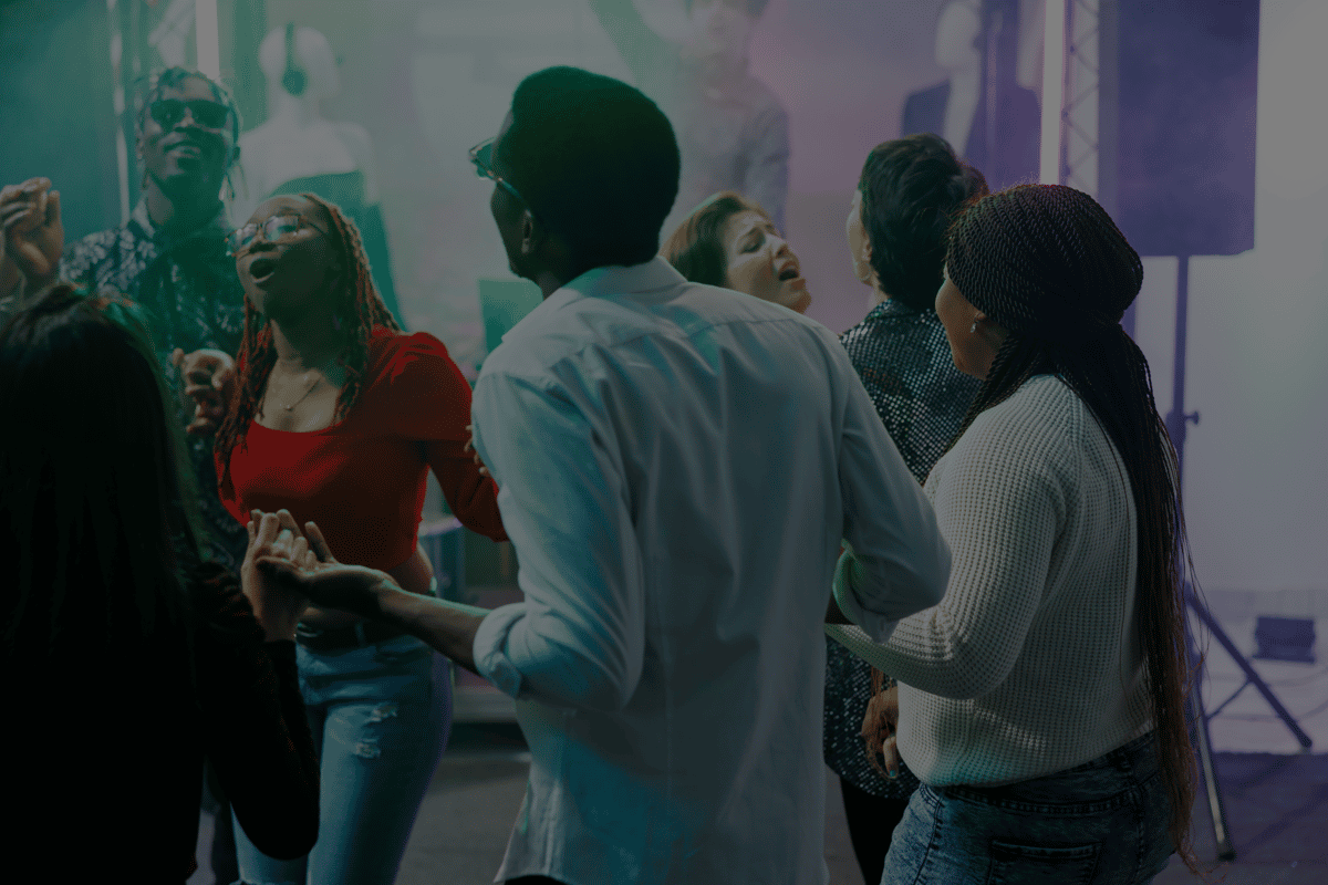 Friends dancing in vibrant nightclub with colorful lighting and energetic party atmosphere, lively social nightlife scene