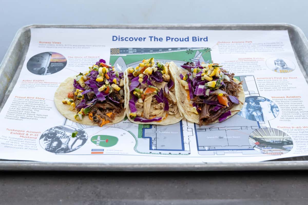Three chicken tacos on a tray