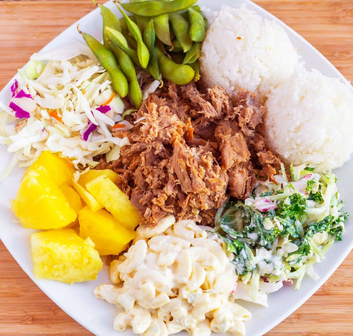 Come with a serving of one scoop of rice, one scoop of macaroni salad and dressing. Marinated pork shoulder finely shredded and chunky slow cooked with Hawaiian sea salt and Huli huli Teriyaki sauce
Note: can be made Gluten Free (GF) upon request. Also photos are shown with more than two sides for demonstration purpose only.