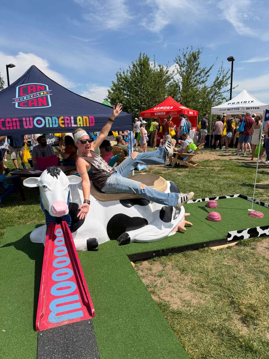 Dani Pinball posing fun on our blue ribbon cow mobile mini golf hole at Minnesota Monthly's 2026 Grill Fest at CHS Field in Saint Paul, Minnesota 