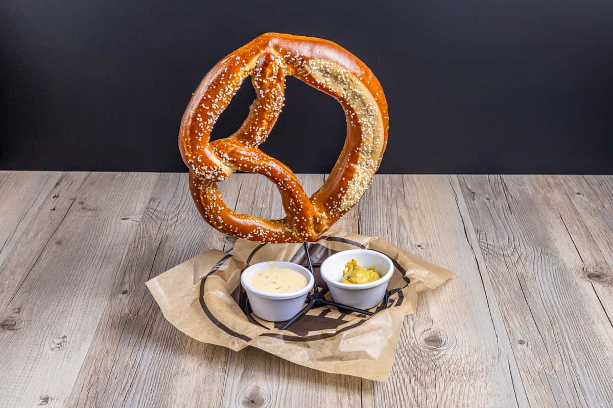 Hanging pretzel with two dipping sauce cups