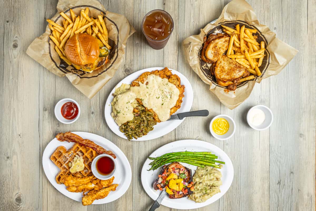 Top down view of multiple Spechts Texas dishes on gray wooden table