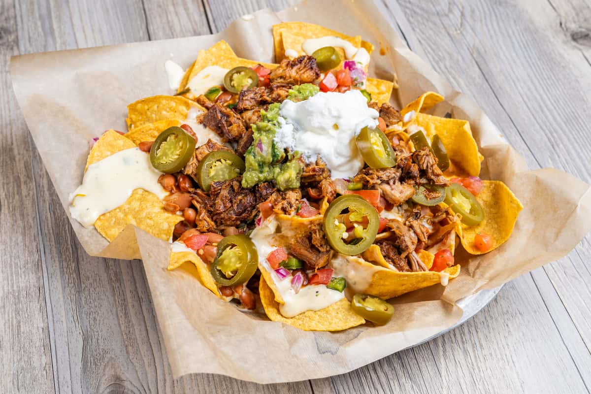 Supreme nachos in paper and basket