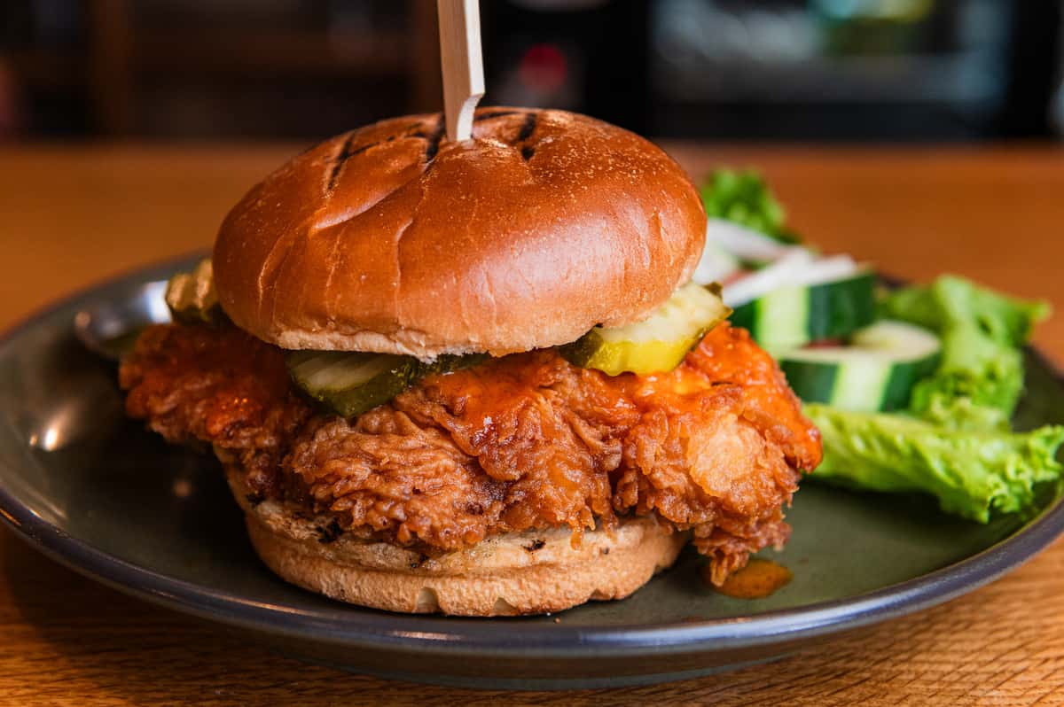 Our fowl reckoning chicken sandwich with buffalo sauce, honey, and pickles