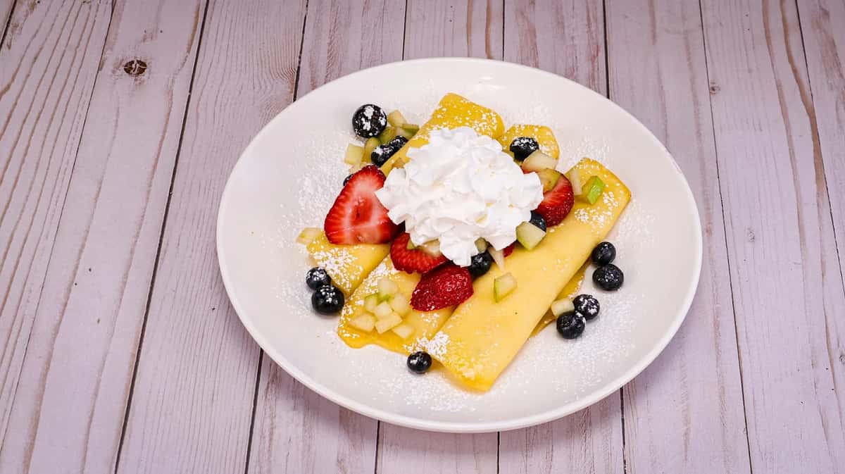 How about a light snack? Then try our fluffy fresh crepes filled with our four-cheese blend and topped with fresh strawberries, blueberries and green apples