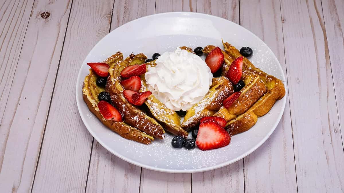 Fluffy thick style French toast topped with fresh seasonal berries